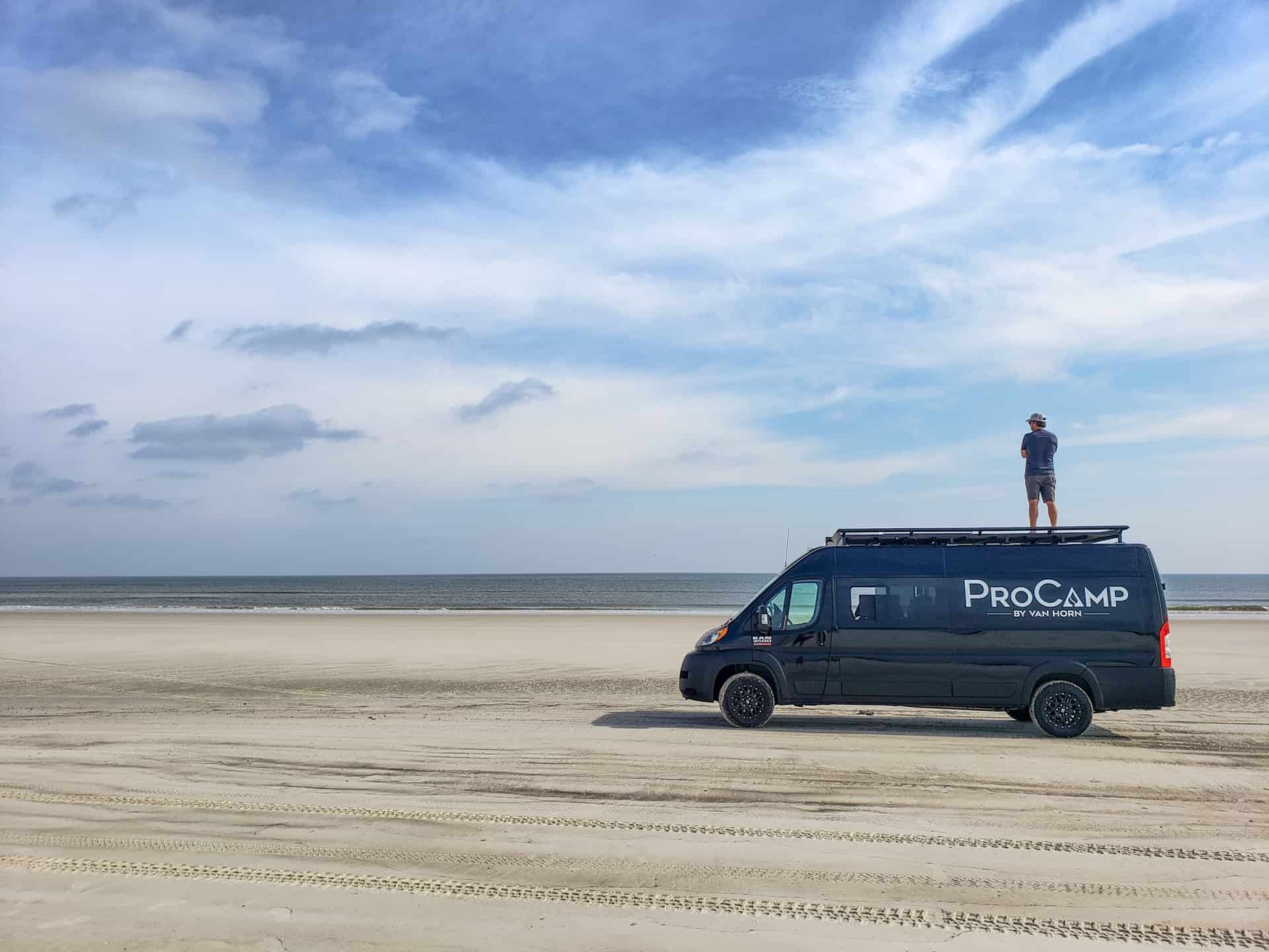 procamp on beach with male standing on top
